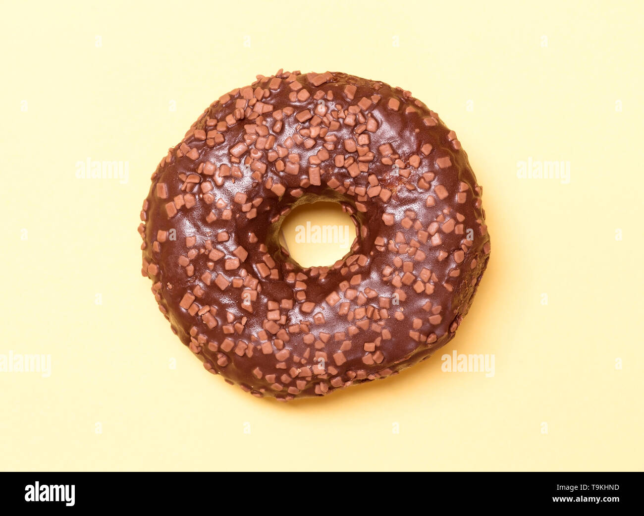 Chocolate donut on yellow background Stock Photo - Alamy