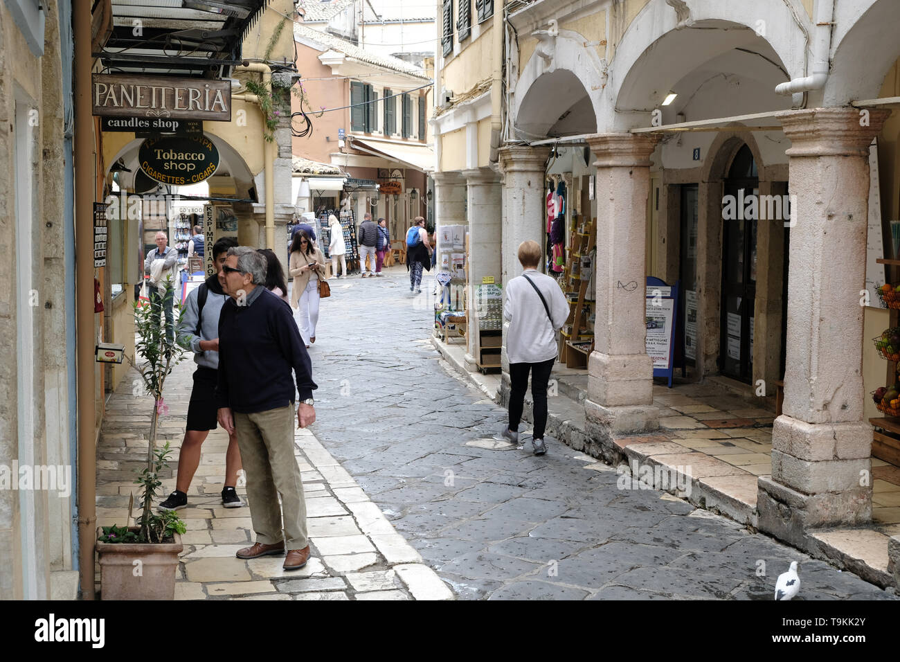 May, 2019 - Tourists and locals shop along the narrow streets of the old  town in Corfu, Greece Stock Photo