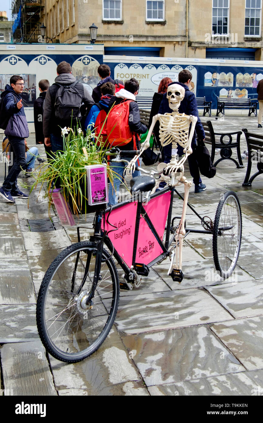 Bizarre Bath, skeleton on a bike; Bath abbey courtyard Stock Photo