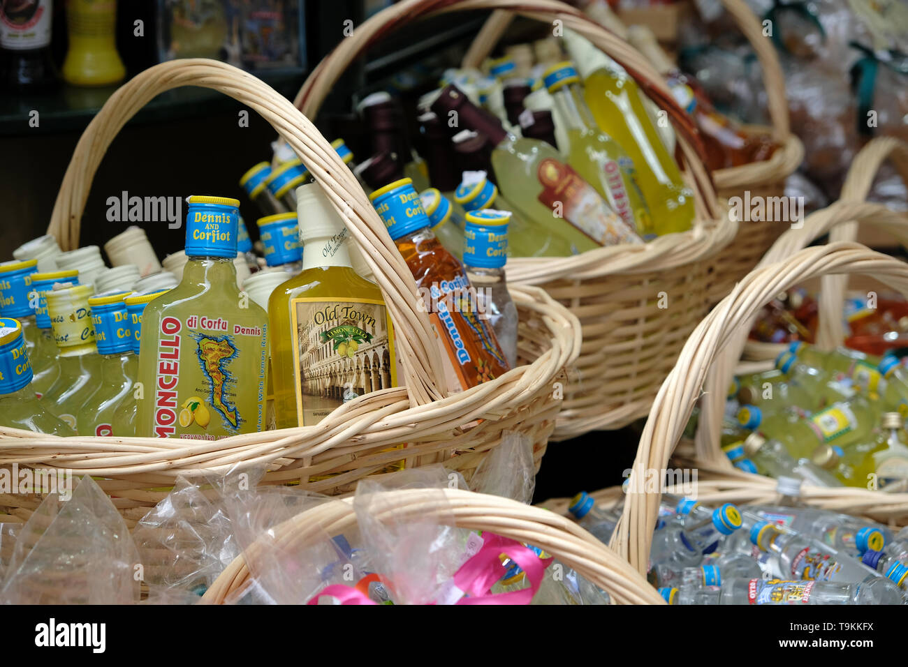 Corfu, Greece - May 10, 2019 - Baskets full of small alcohol bottles which are sold throughout Corfu town Stock Photo