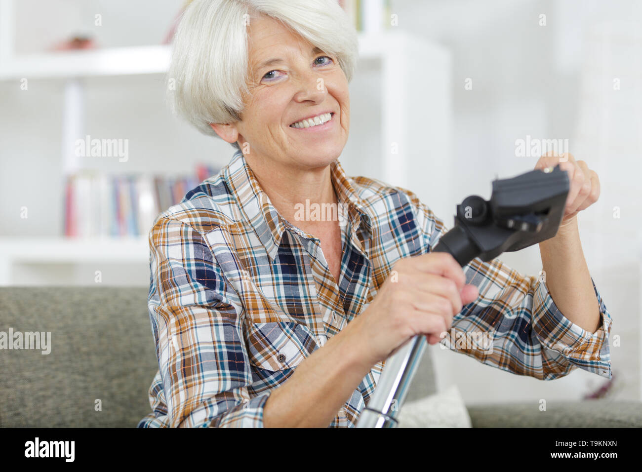senior woman before vacuuming a carpet Stock Photo - Alamy