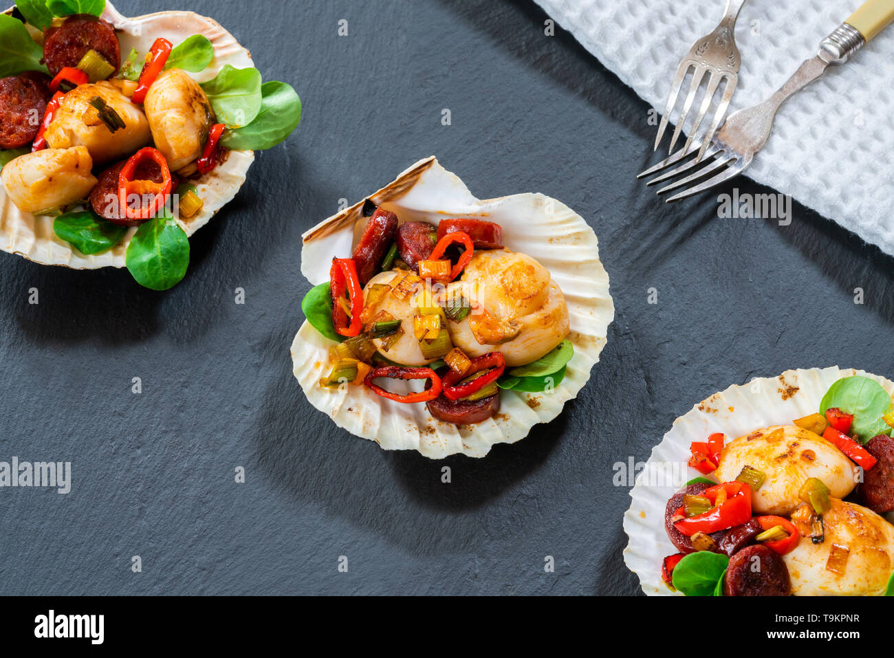 Spiced scallops with chorizo and chili in shells top view Stock Photo