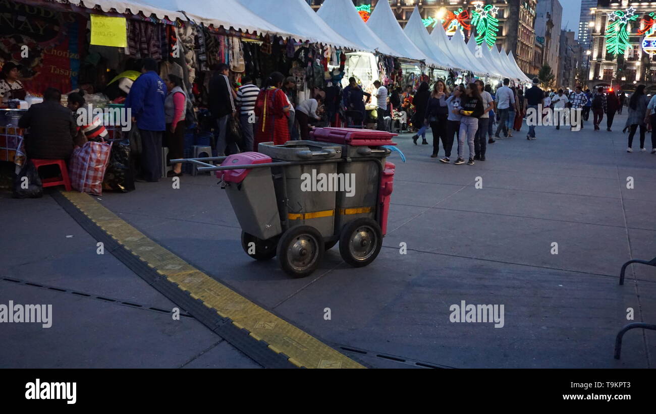 Public trash cans with market behind, Historical Center, Plaza de la Constitucion, Zocalo, Mexico City in early January. Stock Photo