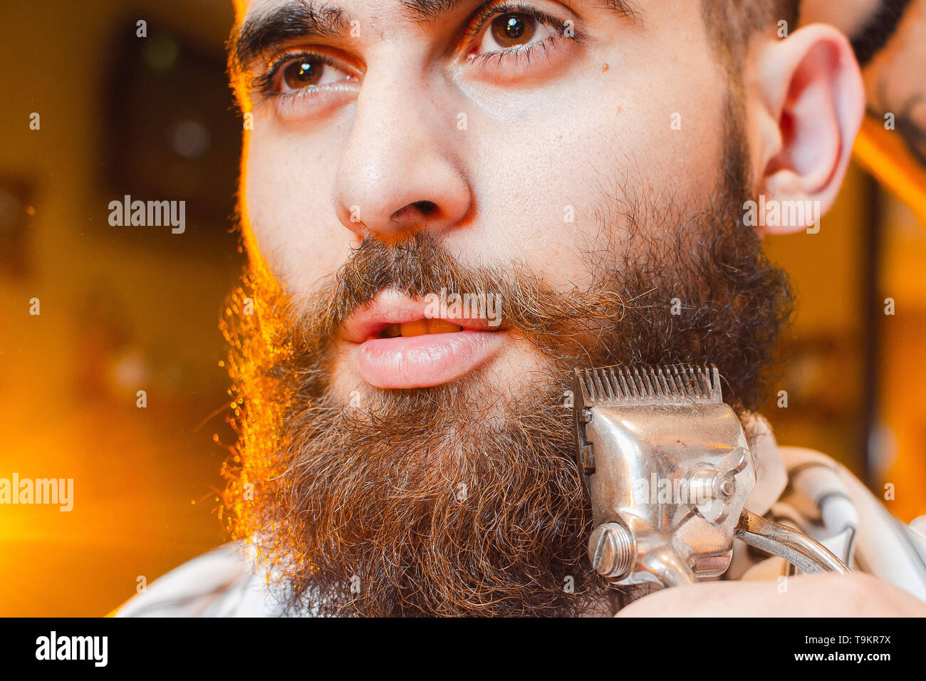 Barber Cuts A Beard Of Vintage Hair Clippers To A Young Handsome