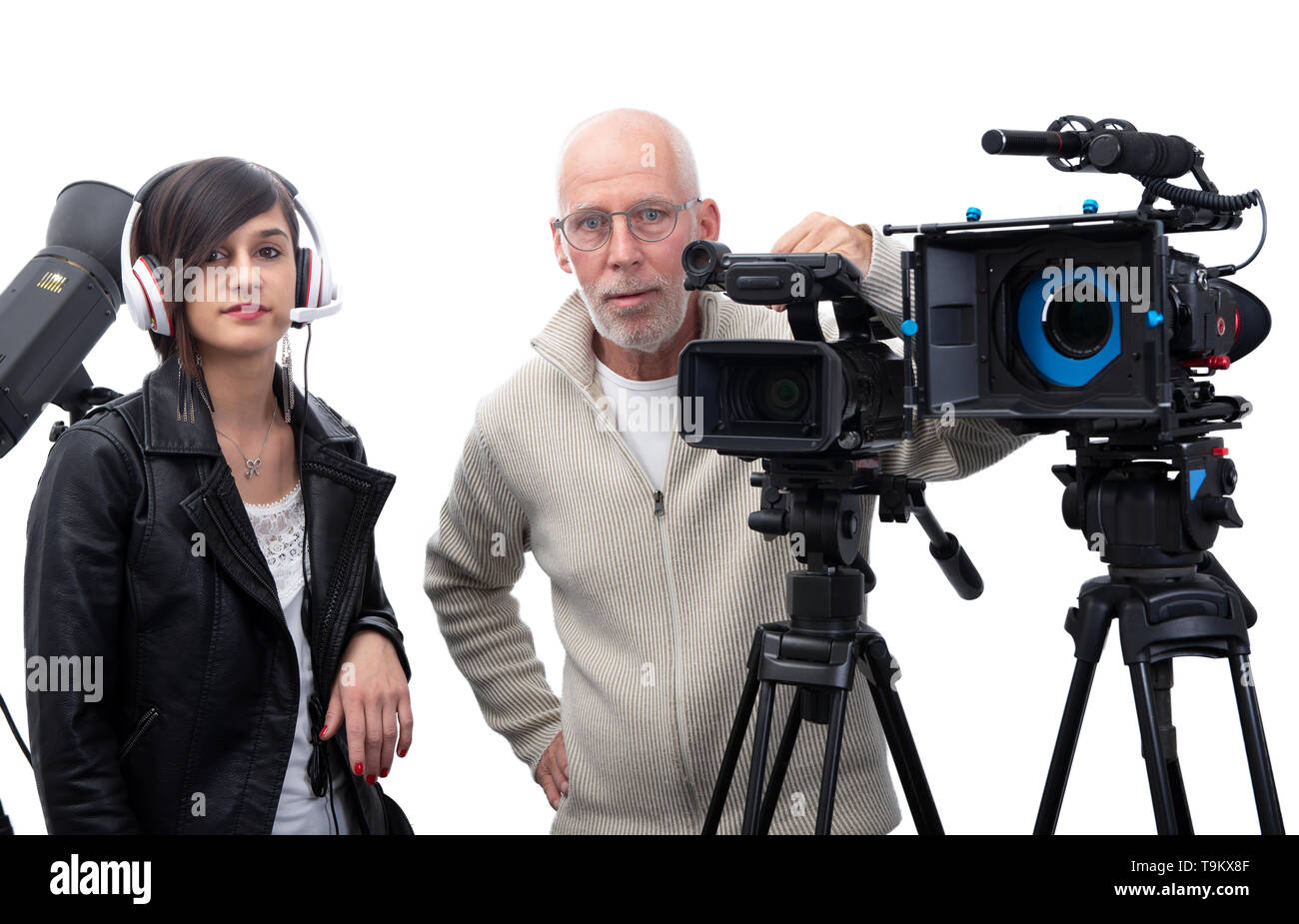 A cameraman and a young woman with a movie camera DSLR isolated on the ...