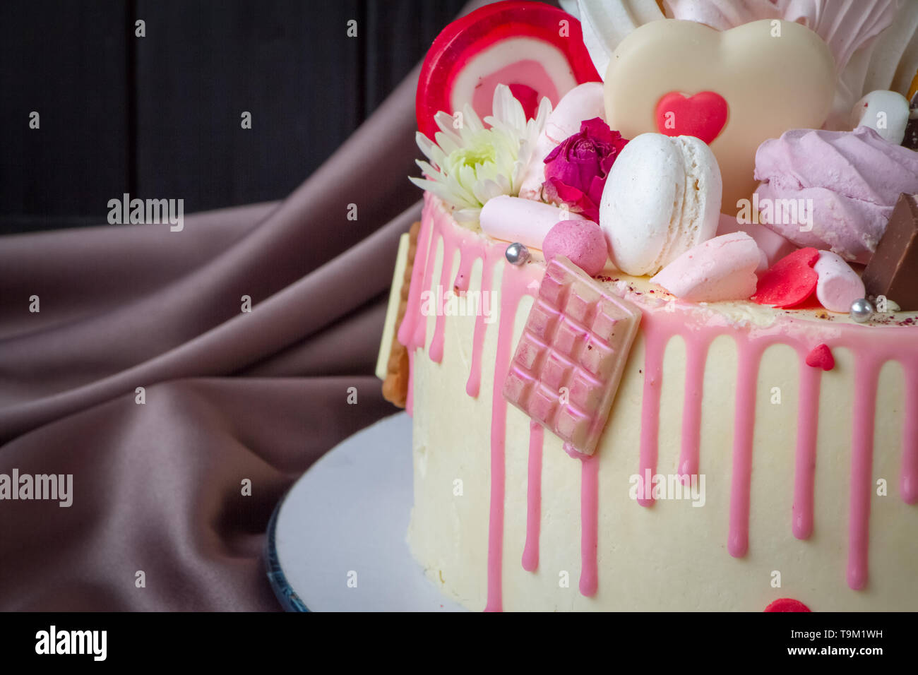 Closeup of black and white chocolate sponge cake with pink and ...