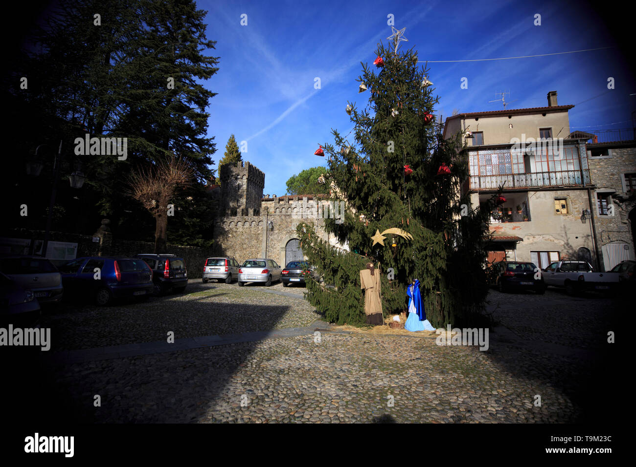 Lunigiana; Italy December 29, 2012: a square in Lunigiana with Christmas tree and some cars parked. In Lunigiana there are many medieval towns Stock Photo