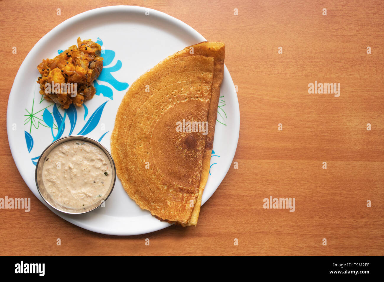 Maida Dosa with Coconut chutney and potato or aloo currey in plate Stock Photo