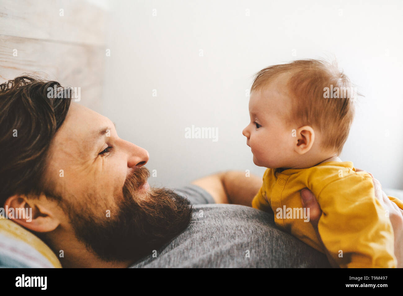 Father and baby daughter playing together family home lifestyle dad and child parenthood love emotions concept Stock Photo