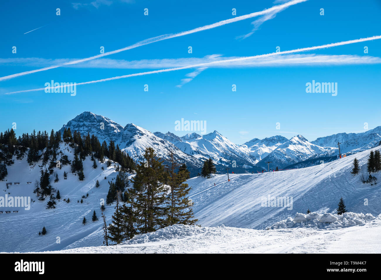 Panorama view of  snow covered Austrian Alps in winter on top of Reutte cable car station, with ski slop in foreground, Tyrol, Austria Stock Photo