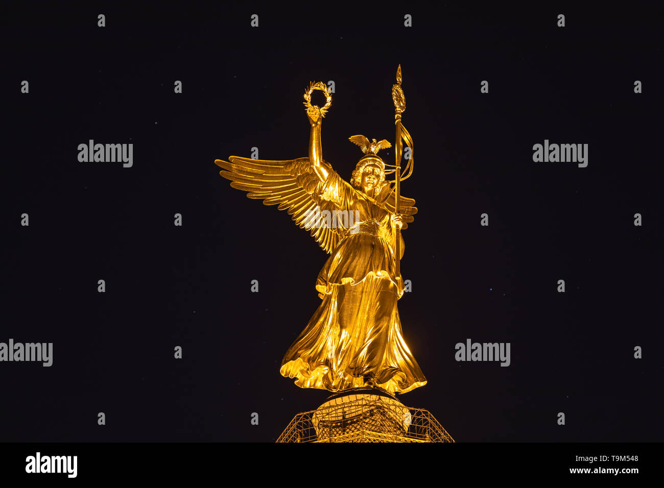 Night view of the golden statue of Victoria on top of the Victory Column, located at Great Star square in Berlin, Germany Stock Photo