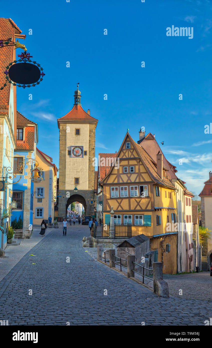 Symbolic view of the medieval old town Rothenburg ob der Tauber at Ploenlein before sunset with beautiful golden sunlight falling on the historical bu Stock Photo