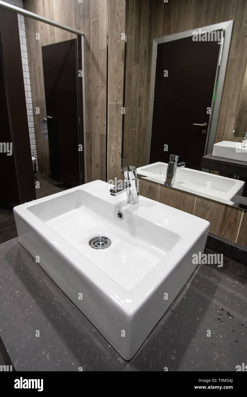 Modern Public toilet room with washing hands. Spain Stock Photo