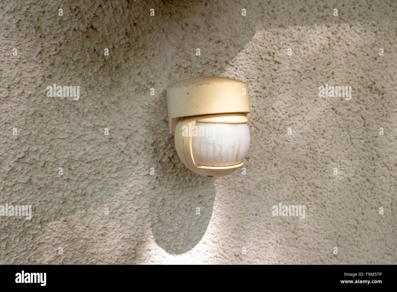Motion detector on a house wall for quick light adjustment Stock Photo