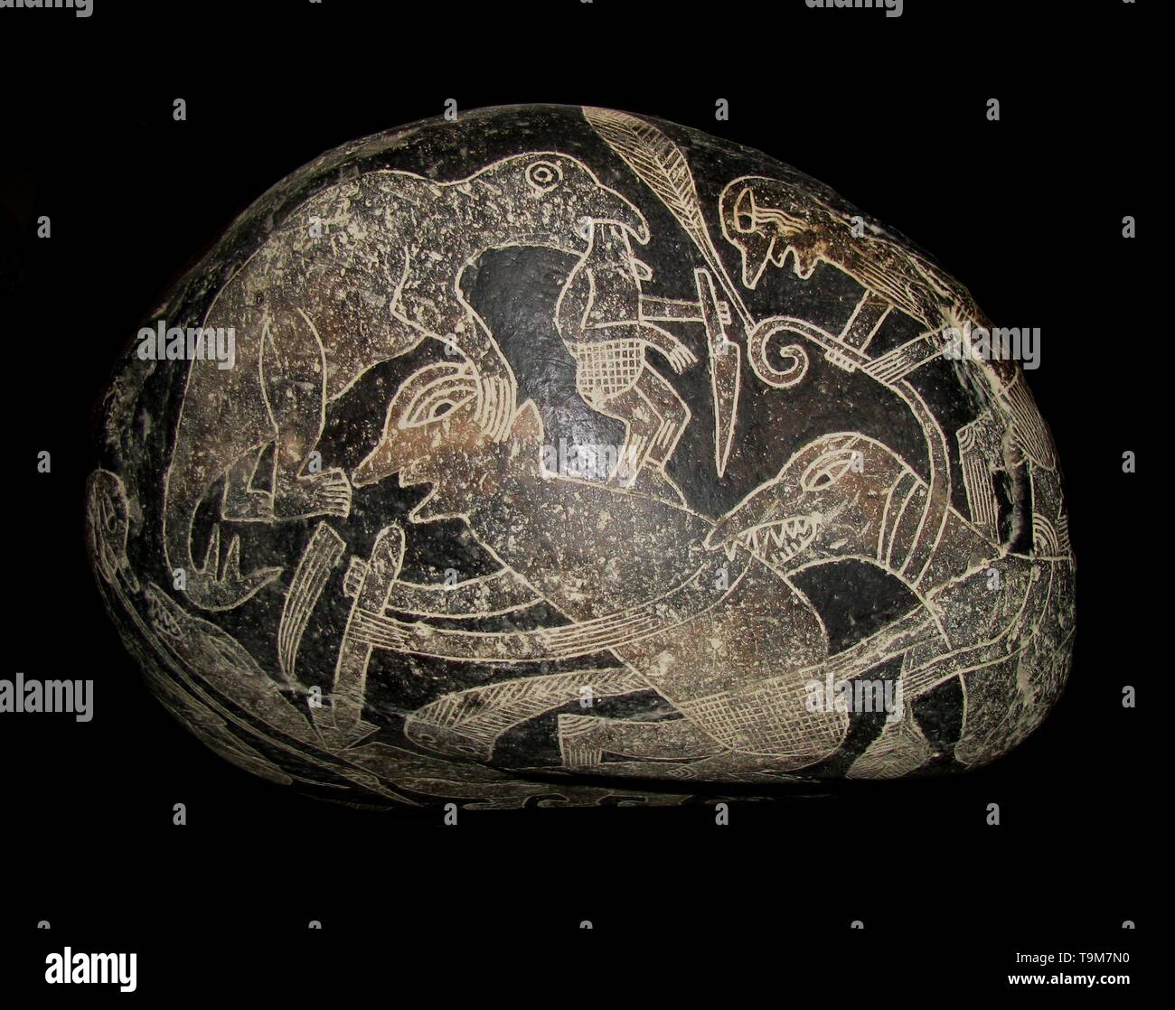 The ica stone. A dinosaur killing a man. Museum: Museo de piedras grabadas de Ica. Author: The Ica stones. Stock Photo