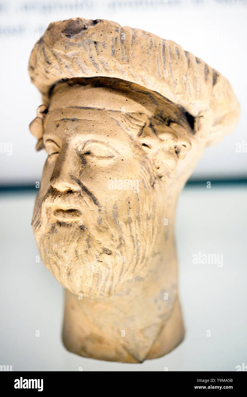 Terracotta head of Dionysos from a group showing him reclining on a ...