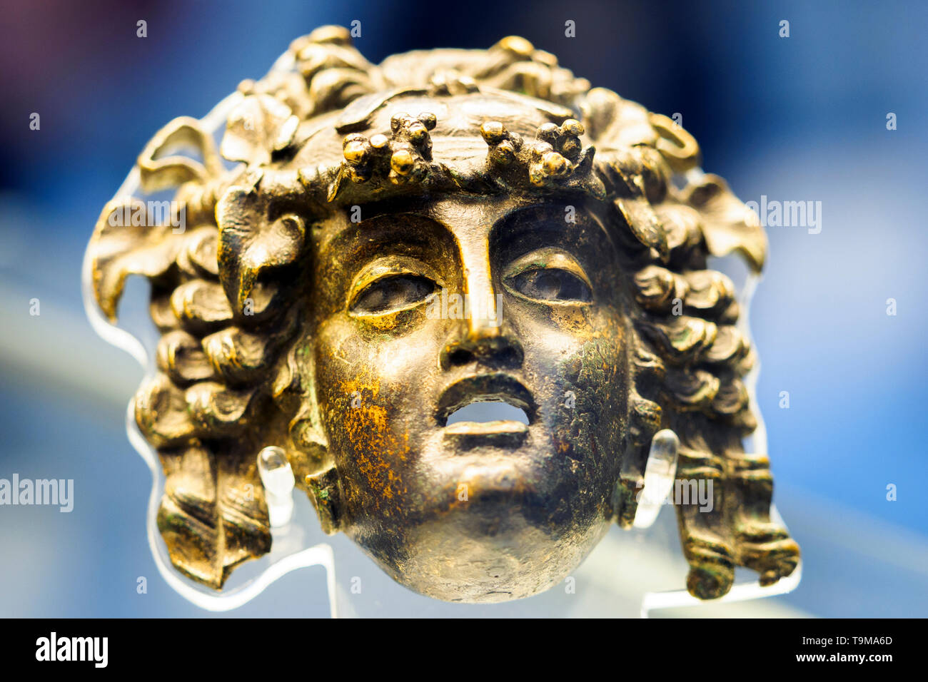 Bronze mask of a maenad ( a female follower of the wine god Bacchus) Roman about 1st century AD A decorative attachment from a piece of furniture Stock Photo