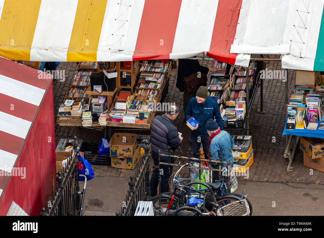Book buyers and sellers at a Cambridge Market stall. Stock Photo