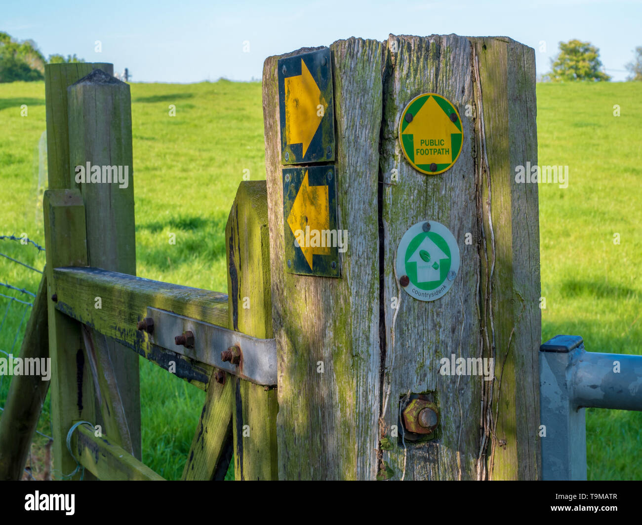 Footpath signs, markers and pointer on a rural walking route pointing multiple directions to guide walkers and hikers Stock Photo