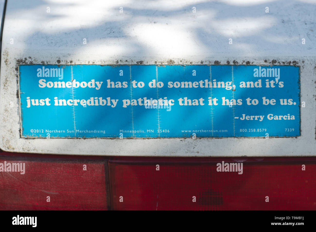 A bumper sticker on a car has a quotation by Jerry Garcia "Somebody