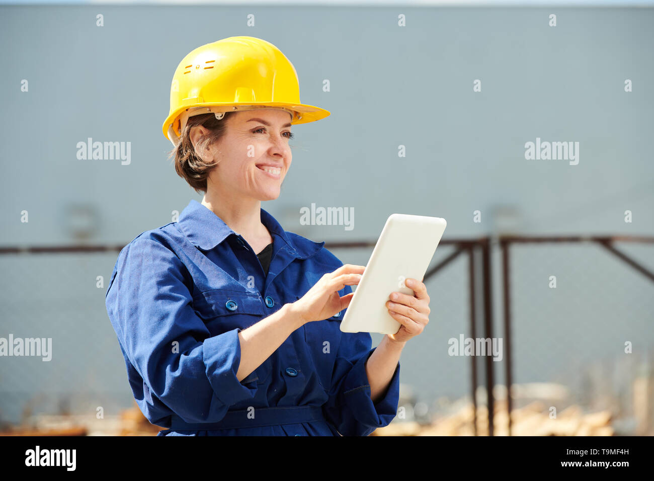 Smiling Female Worker Outdoors Stock Photo