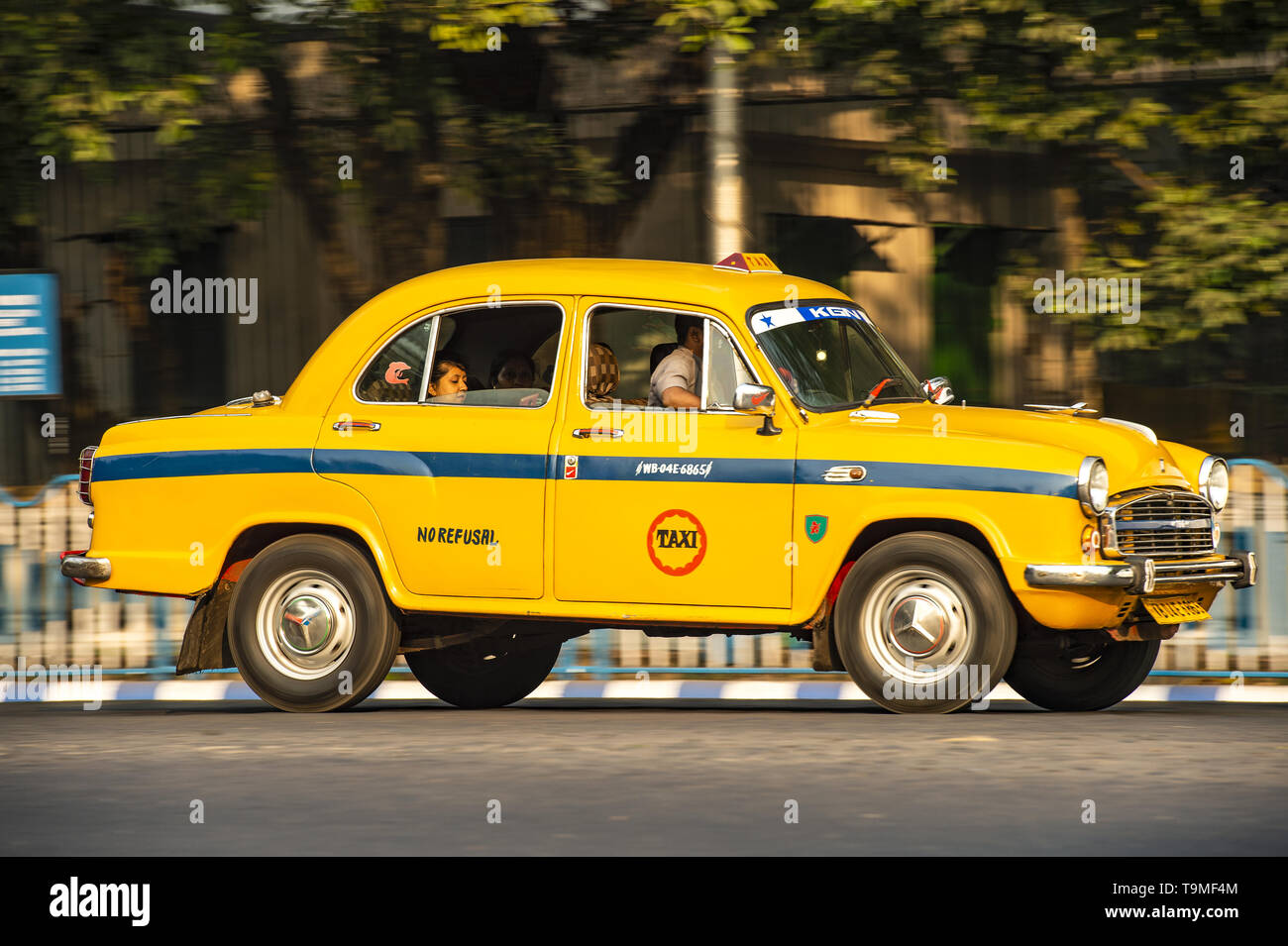 An Ambassador Cab Taxi With Passengers On Board Is Running On The an-ambassador-cab-taxi-with-passengers-on-board-is-running-on-the