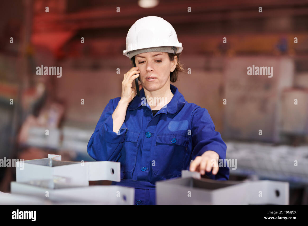 Female Worker Speaking by Phone Stock Photo