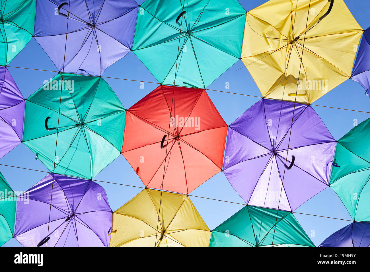 The image of colorful umbrellas on a background of blue sky Stock Photo