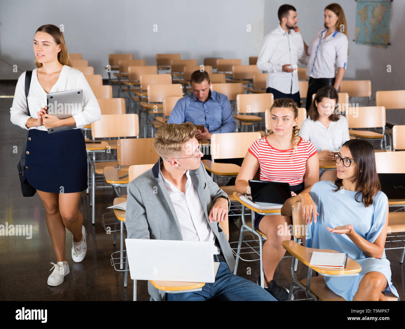 Happy group of adult students lively chatting while enjoying free time