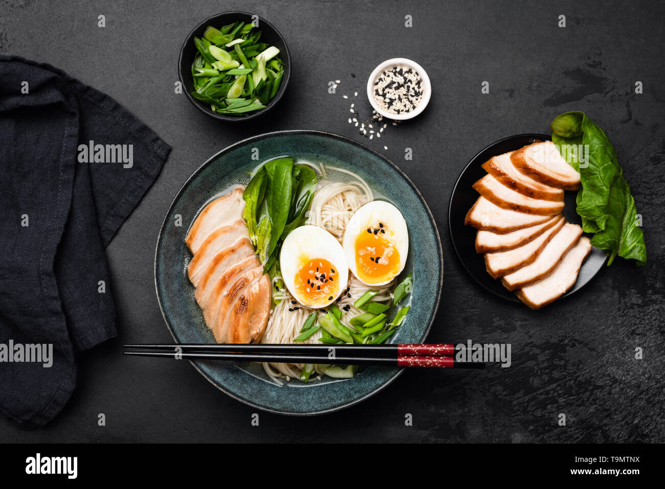 Japanese ramen noodle soup bowl on black stone background. Table top view asian cuisine food. Stock Photo