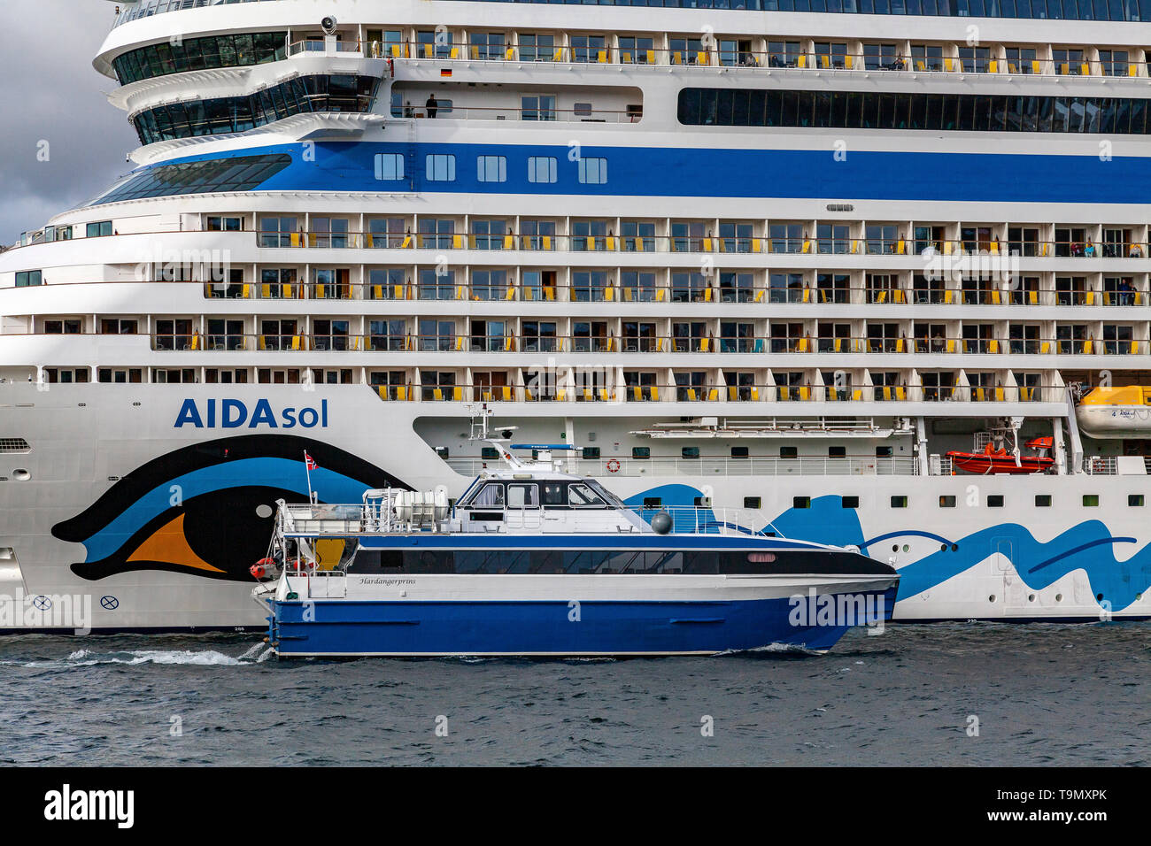 High Speed Passenger Catamaran Hardangerprins Dwarfed In Front Of Cruise Ship Aidasol At Skoltegrunnskaien Terminal In The Port Of Bergen Norway Stock Photo Alamy