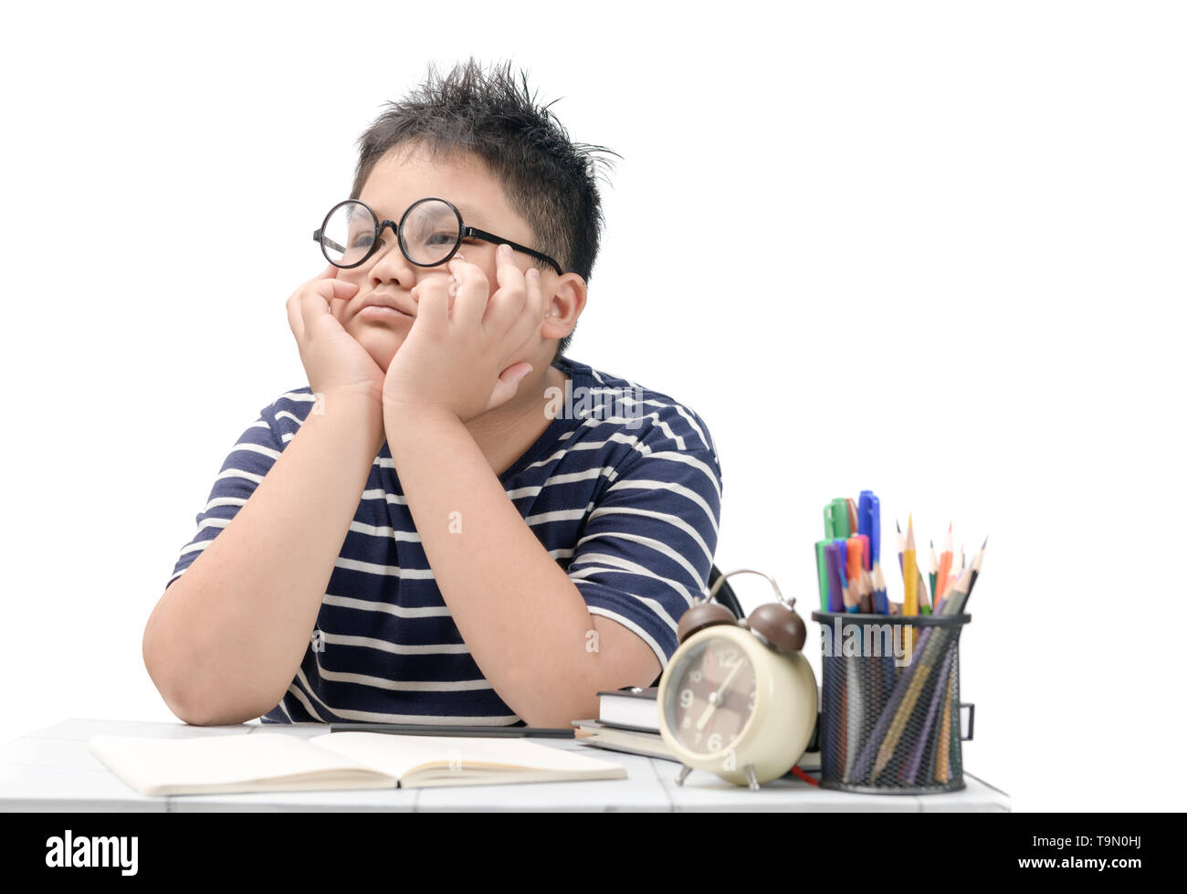 Bored and tired asian student doing homework isolated on white ...