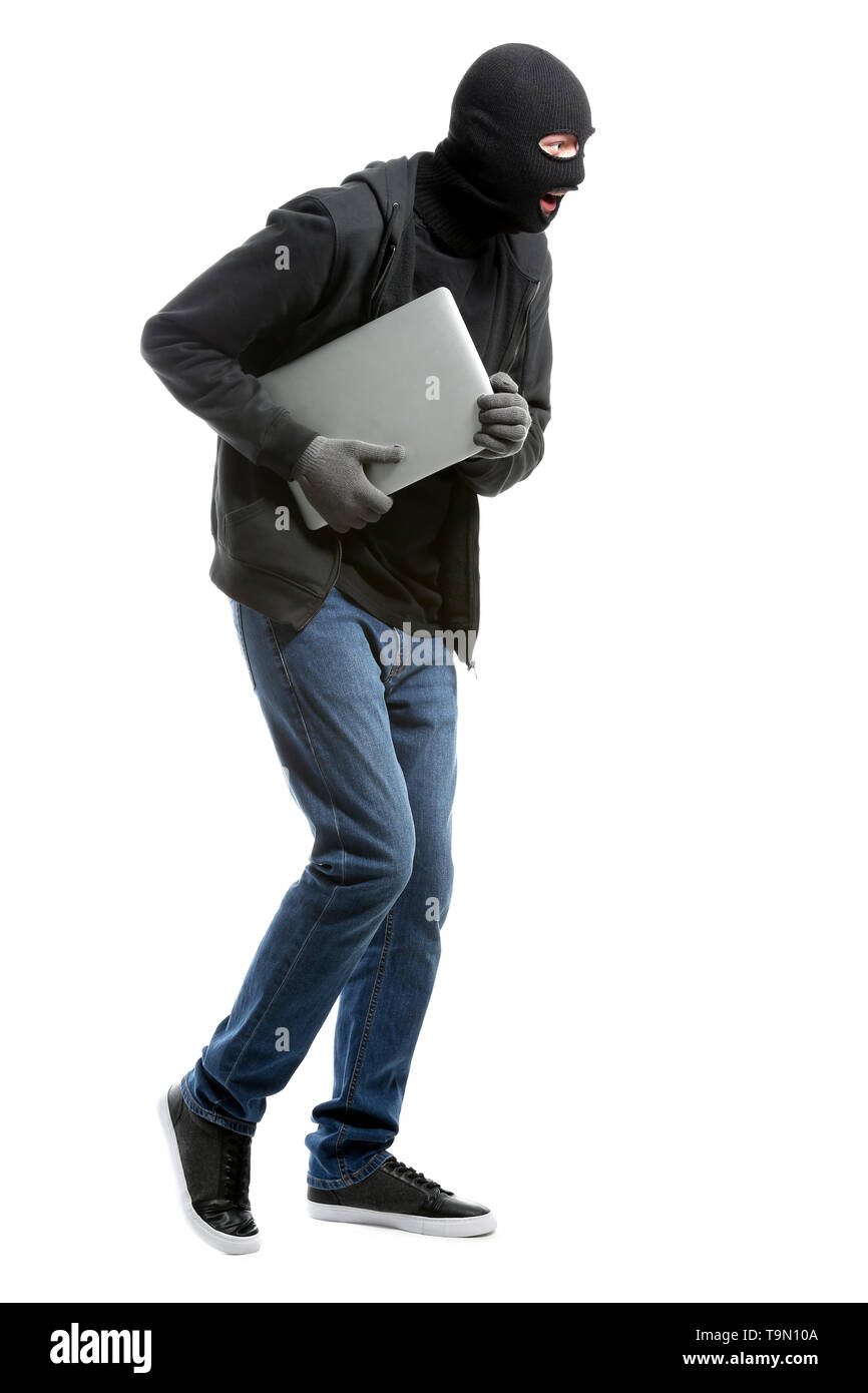 Male thief with laptop on white background Stock Photo