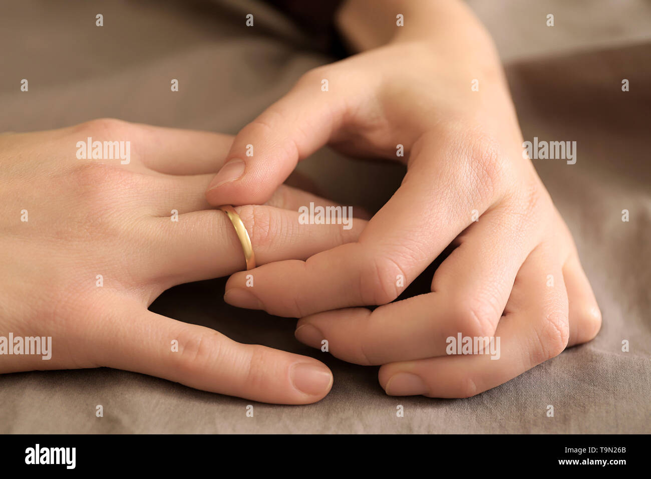 Woman trying to slip ring off her finger, closeup. Concept of divorce Stock  Photo - Alamy