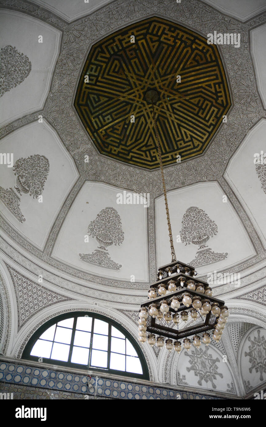 The stucco plaster and woodwork dome and chandelier at the 16th century mausoleum and zawiya of Sidi Mahrez, in the medina of Tunis, Tunisia. Stock Photo