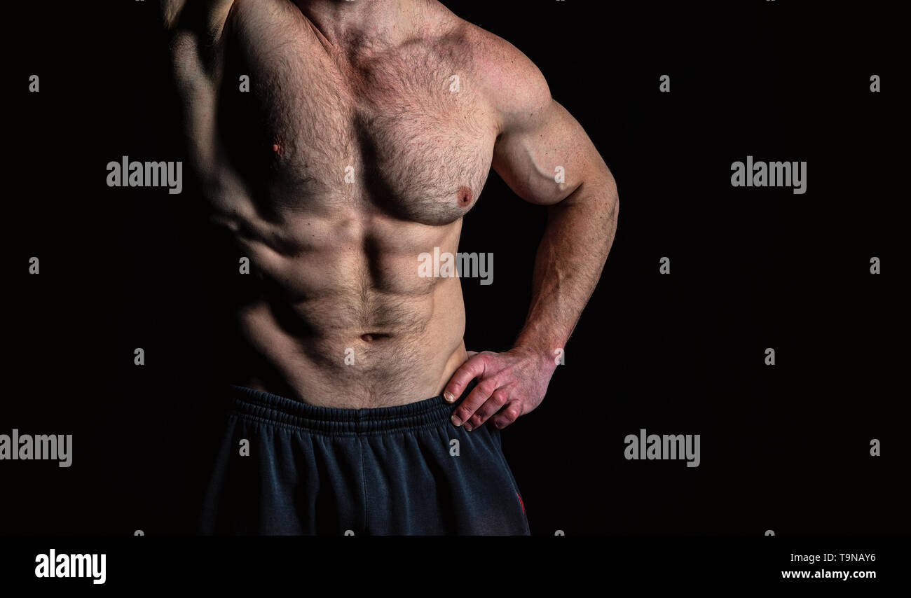 Torso with six pack and ab muscles. Arm with strong biceps and