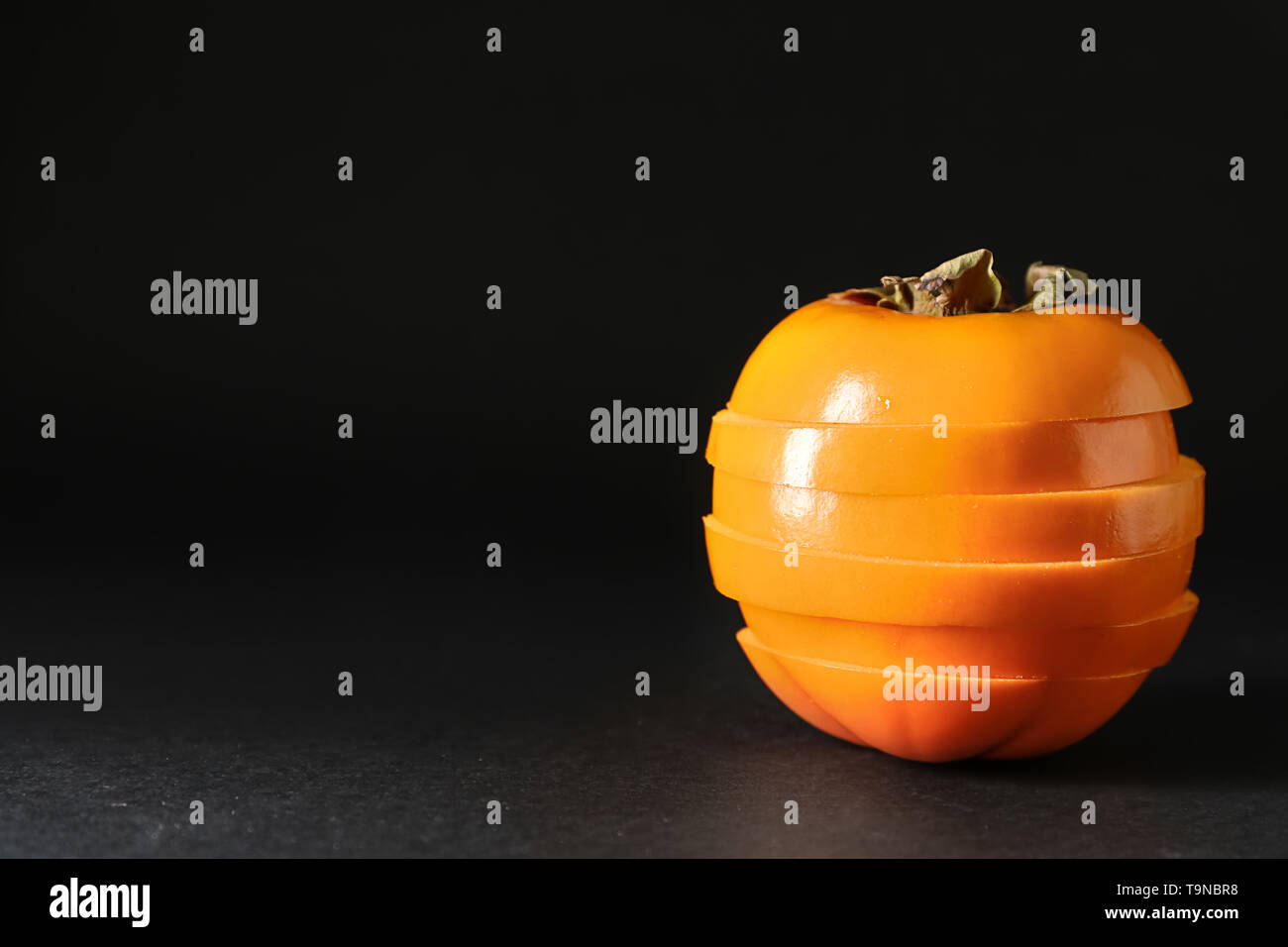 Persimmon on black background hi-res stock photography and images - Alamy