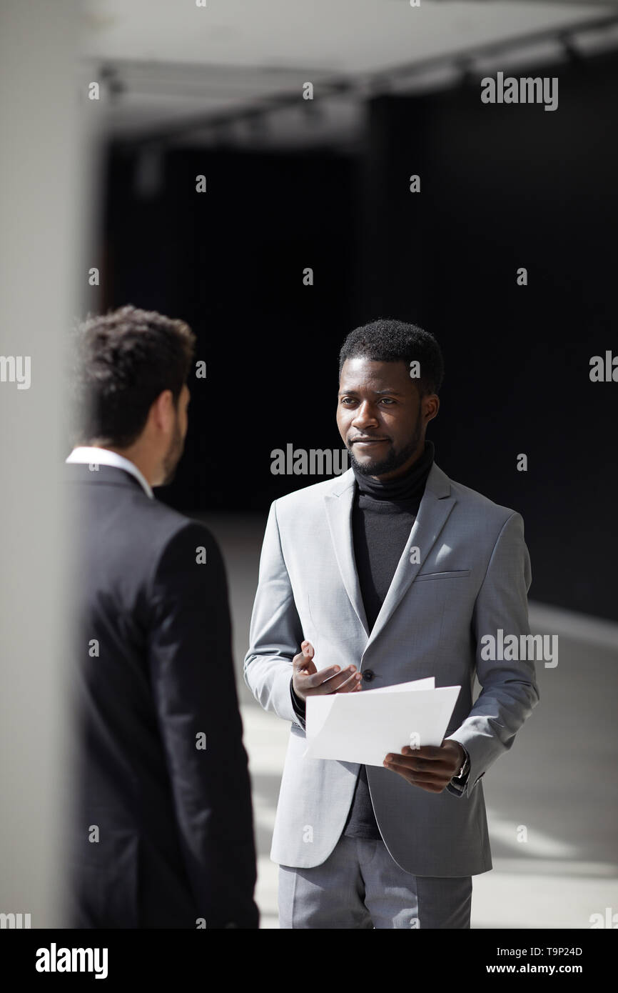 Black businessman talking to colleague Stock Photo