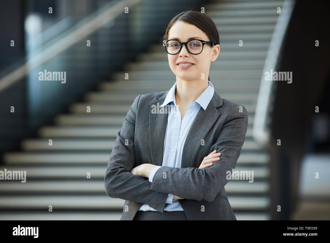 Positive young female intern in glasses Stock Photo