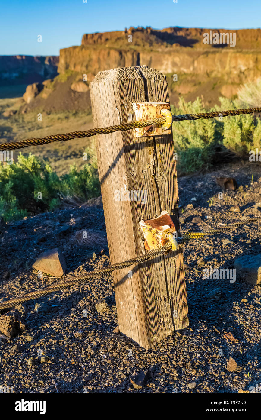 Wooden posts and steel wire form guardrails along Historic U.S. Route 10 Frenchman Coulee near Vantage, Washington State, USA Stock Photo