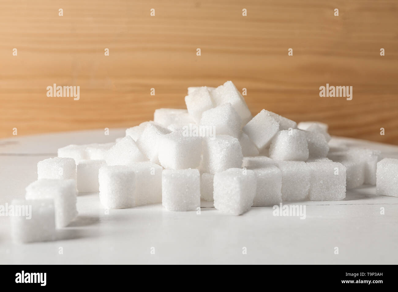 Heap of refined sugar cubes on table Stock Photo