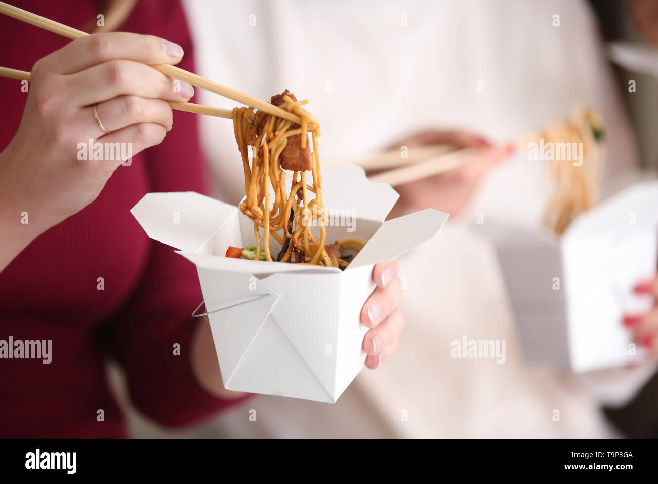 Woman eating chinese noodles from takeaway box, closeup Stock Photo - Alamy