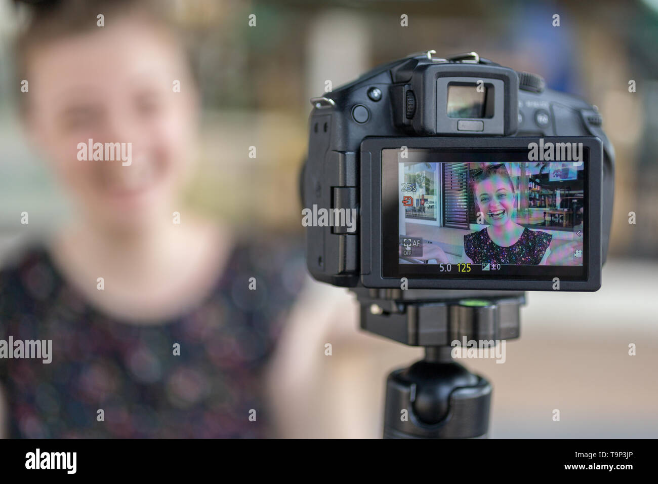 Manila, Philippines - May, 18, 2019: A caucasian young girl making a video blog (vlog) behind the camera Stock Photo