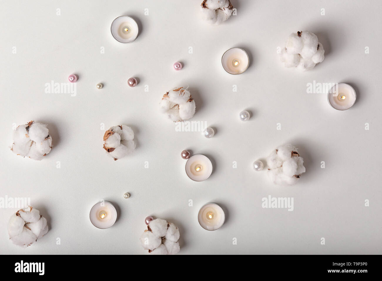 Flat lay composition with burning candles and cotton flowers on white ...