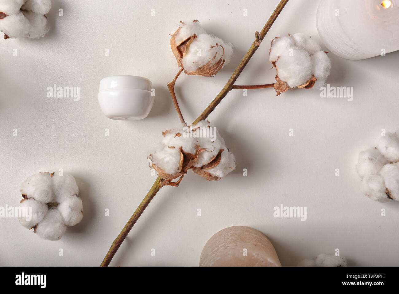 Flat lay composition with burning candles, cotton flowers and cosmetics ...