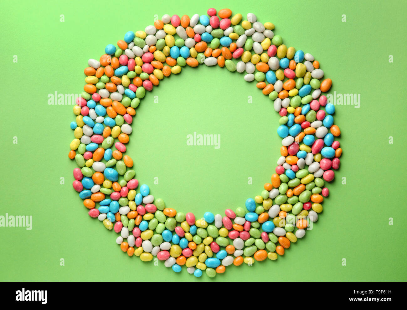Round frame made with tasty candies on color background Stock Photo - Alamy