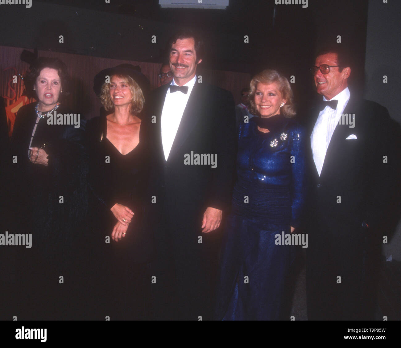 Westwood, California, USA 19th April 1994  Dana Broccoli, actress Maryam d'Abo, actor Timothy Dalton, Luisa MAttioli actor Roger Moore attend 70th Birthday Party for Henry Mancini on April 19, 1994 at Pauley Pavilion at UCLA in Westwood, California, USA. Photo by Barry King/Alamy Stock Photo Stock Photo