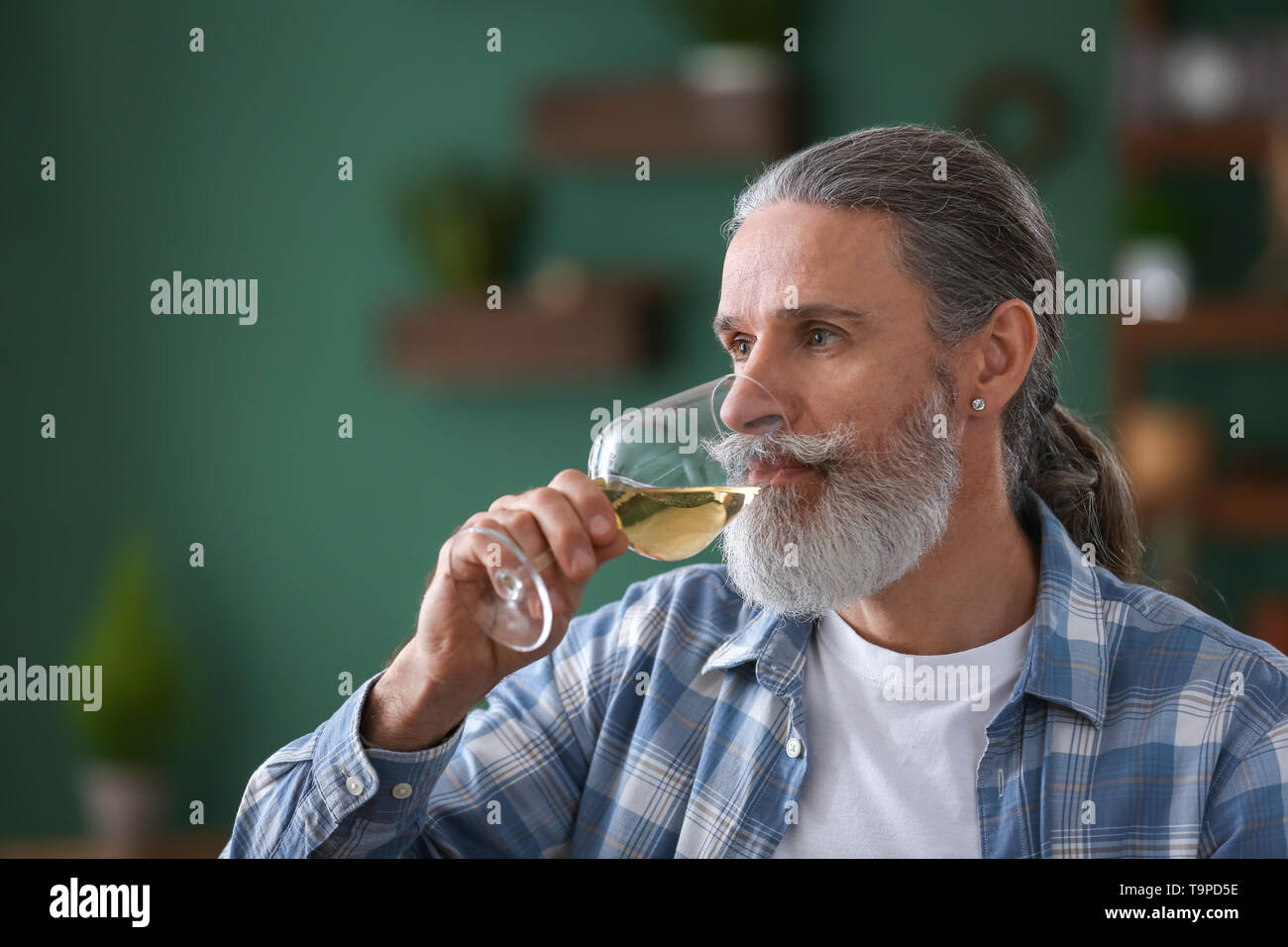 Senior man drinking wine at home Stock Photo - Alamy