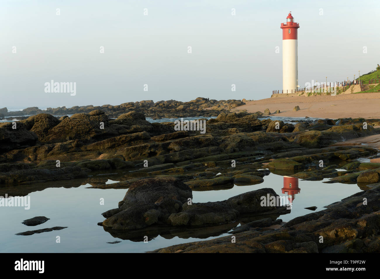 Reflection of Umhlanga Rocks lighthouse in tidal rock pools, McCausland