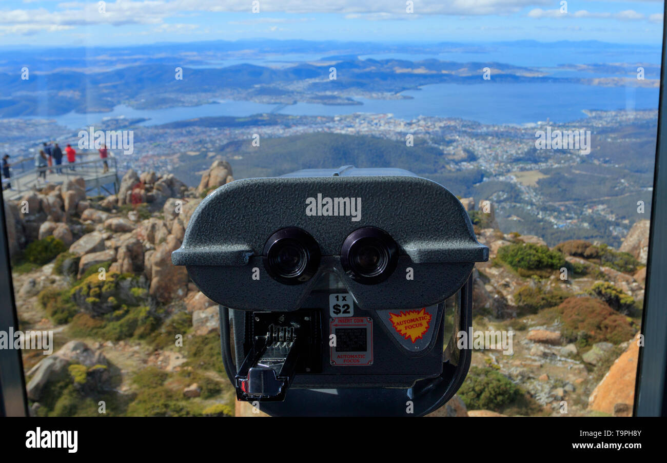 Binoculars inside the Pinnacle Observation Shelter look out over Hobart at Mount Wellington outside Hobart Tasmania.   Mount Wellington's indigenous n Stock Photo